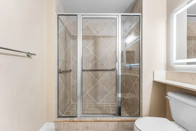 a bathroom with a toilet and a shower