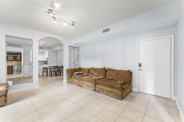 a living room with furniture and a dining table
