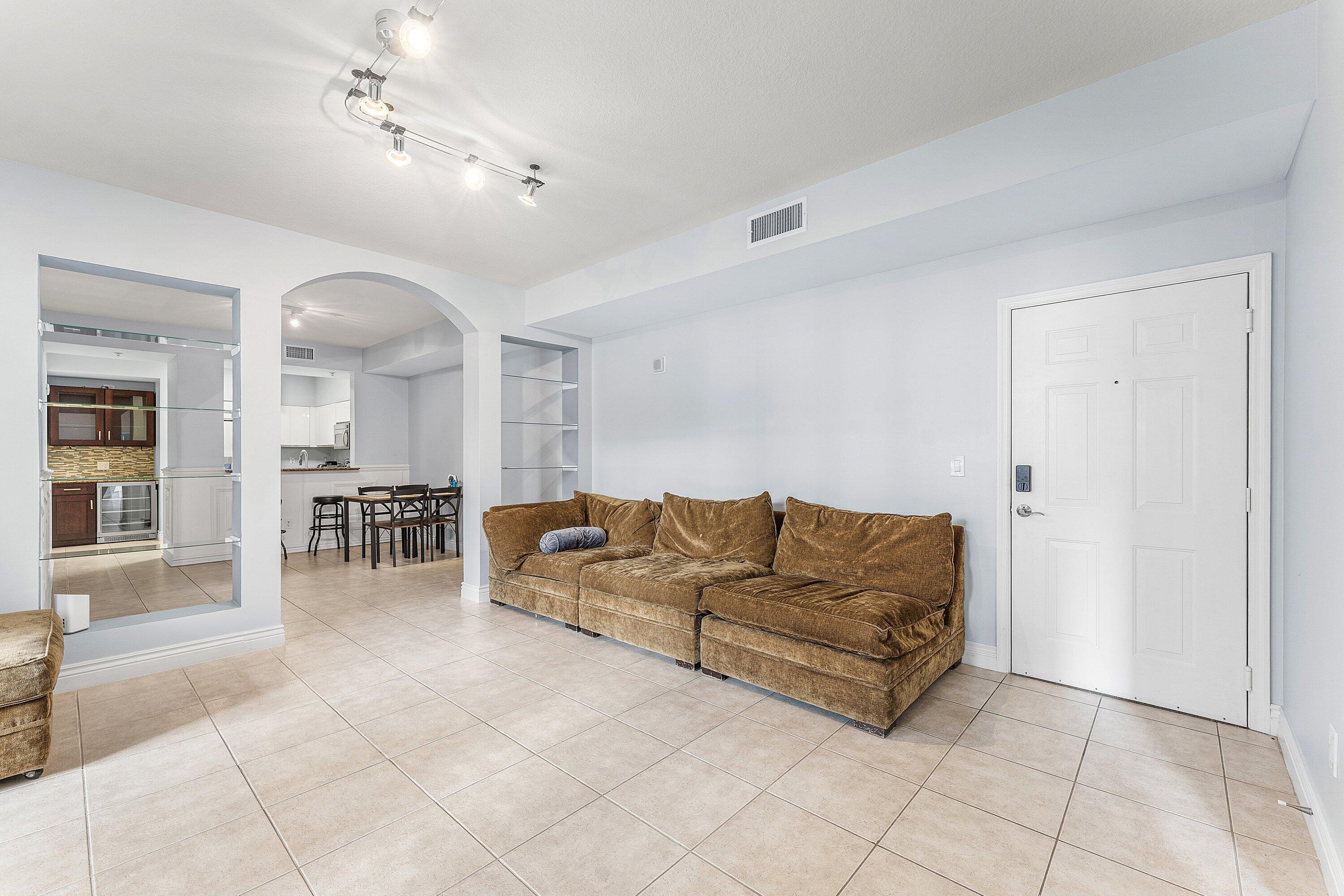 233 South Federal Highway, Unit 308 Boca Raton, FL 33432 - Photo 2 of 44 a living room with furniture and a dining table