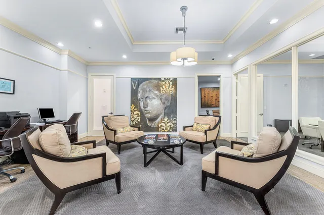 a living room with furniture kitchen and a chandelier