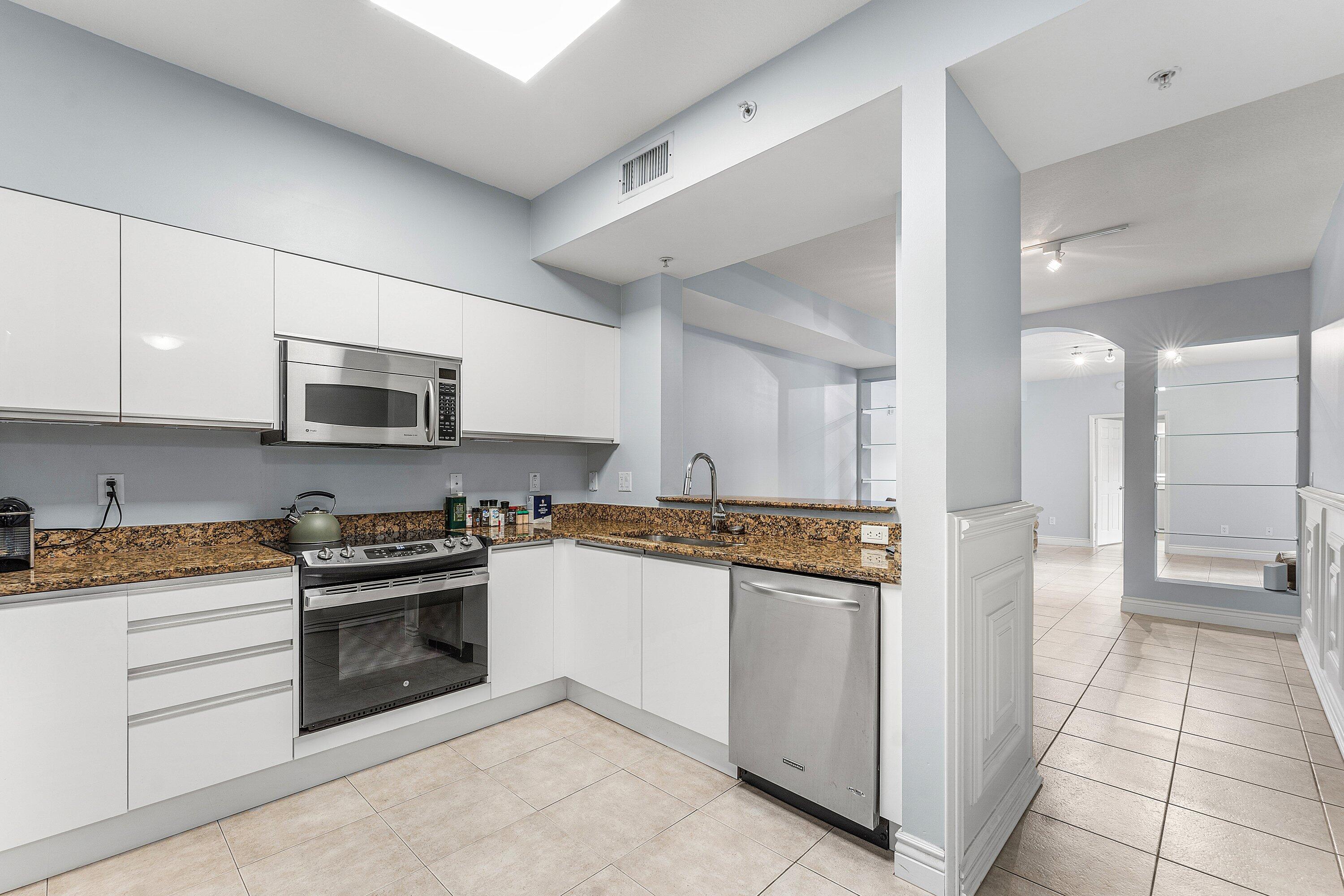 233 South Federal Highway, Unit 308 Boca Raton, FL 33432 - Photo 6 of 44 a kitchen with stainless steel appliances granite countertop a stove and a refrigerator