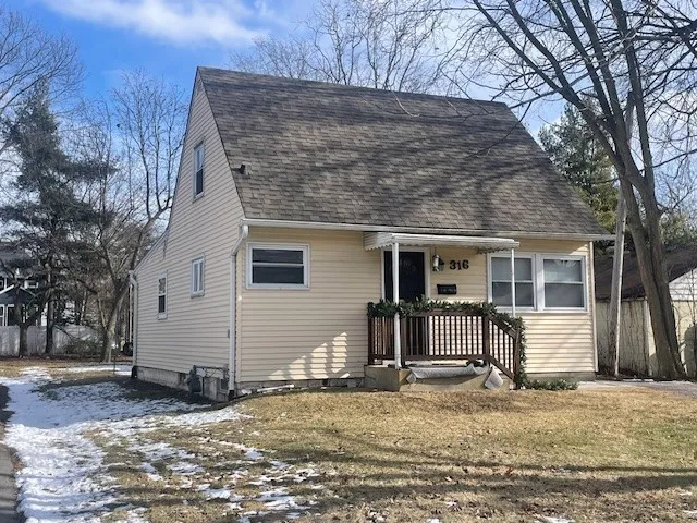 a view of a house with a yard covered in snow