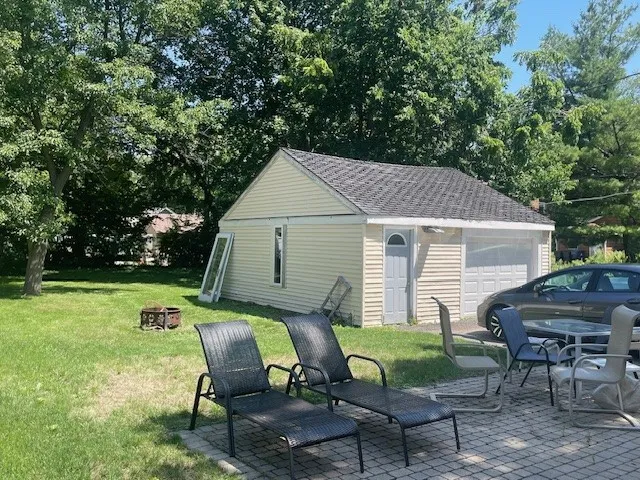a view of backyard of house and outdoor seating
