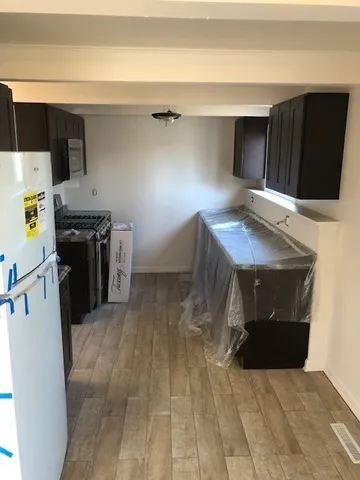 a kitchen with a stove and a refrigerator
