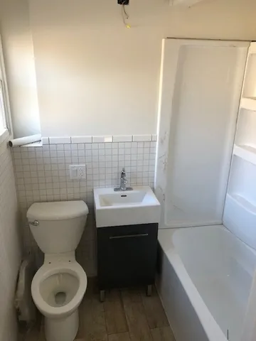 a bathroom with a sink a toilet and bathtub
