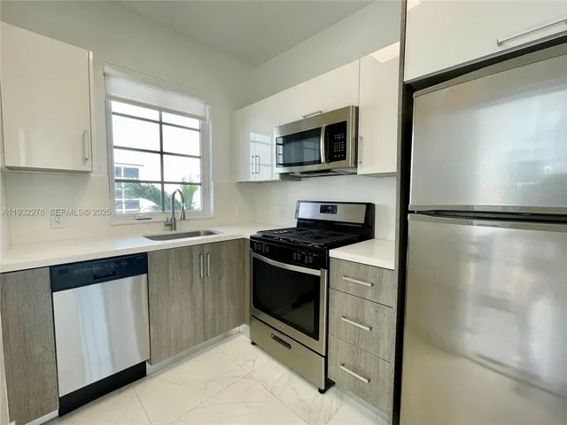 a kitchen with a stove microwave and a refrigerator