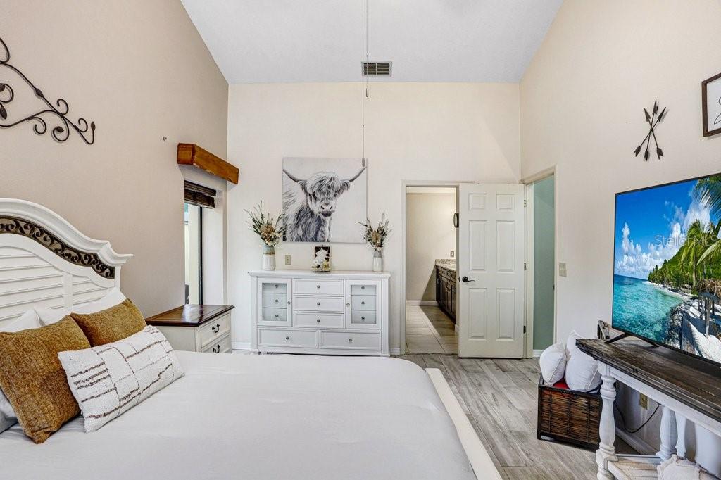 504 Triple Crown Court Seffner, FL 33584 - Photo 20 of 63 a bedroom with a bed and a potted plant