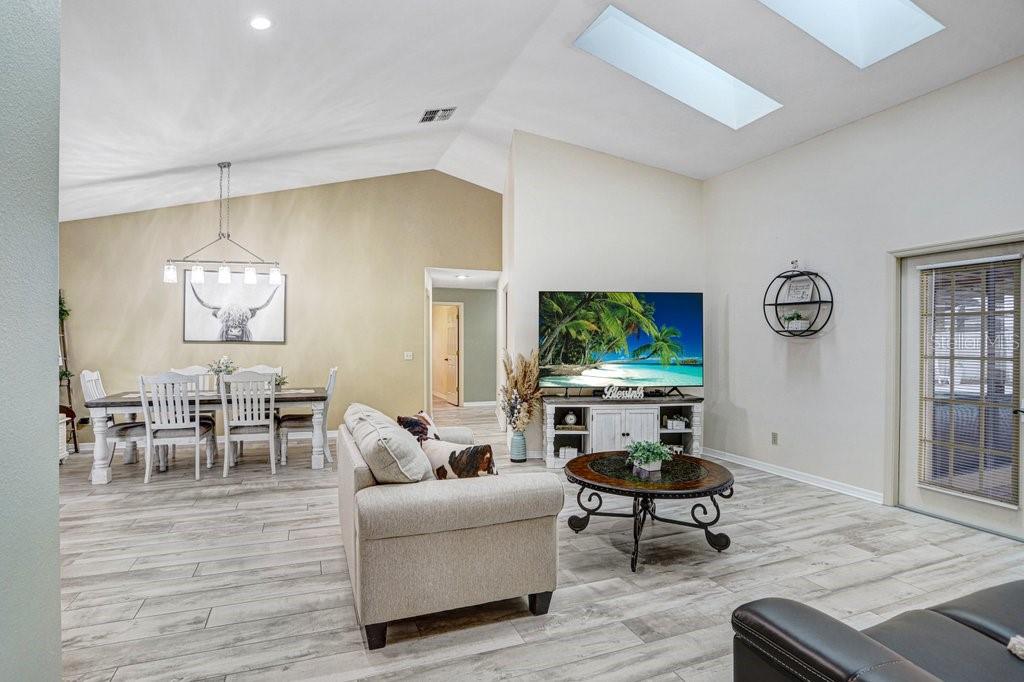 504 Triple Crown Court Seffner, FL 33584 - Photo 27 of 63 a living room with furniture a window and a flat screen tv