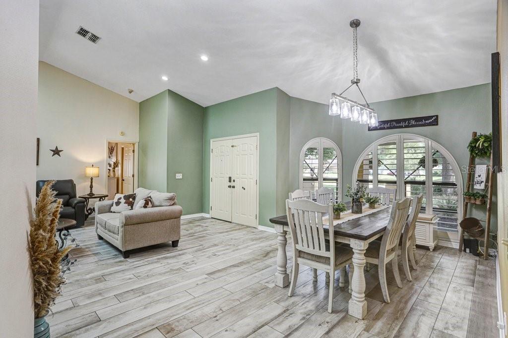 504 Triple Crown Court Seffner, FL 33584 - Photo 28 of 63 a view of a dining room with furniture a chandelier and wooden floor