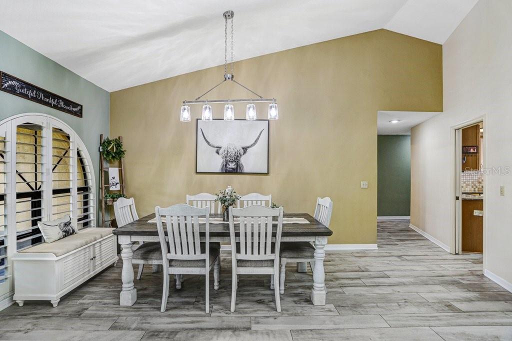 504 Triple Crown Court Seffner, FL 33584 - Photo 31 of 63 a dining room with furniture a window and wooden floor