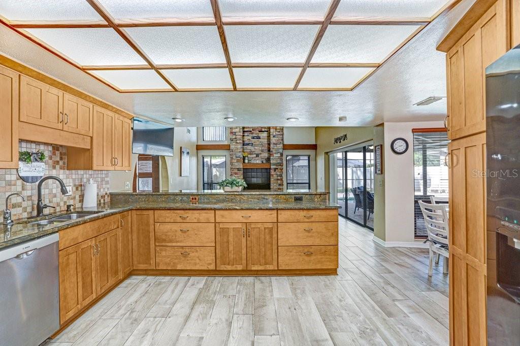 504 Triple Crown Court Seffner, FL 33584 - Photo 32 of 63 a large kitchen with a lot of counter space and wooden floor