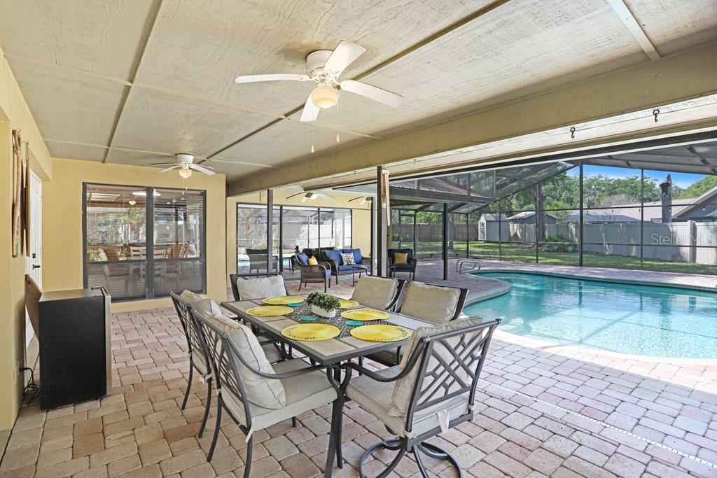 504 Triple Crown Court Seffner, FL 33584 - Photo 39 of 63 a view of a dining room with furniture wooden floor and a chandelier
