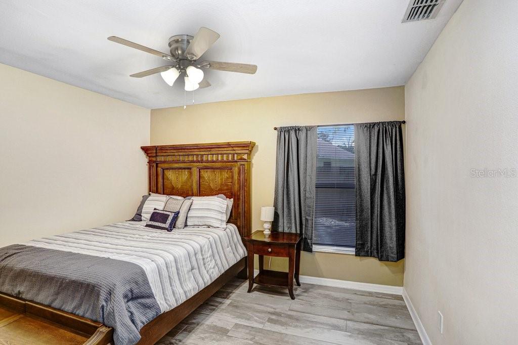 504 Triple Crown Court Seffner, FL 33584 - Photo 48 of 63 a bedroom with a bed and a chandelier