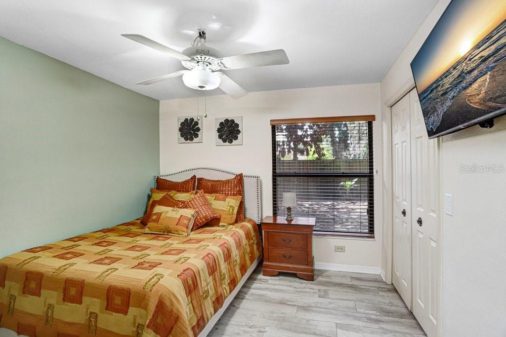 504 Triple Crown Court Seffner, FL 33584 - Photo 49 of 63 a bedroom with a large bed and a chandelier