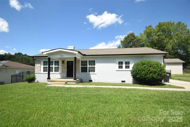 a front view of a house with a yard and porch