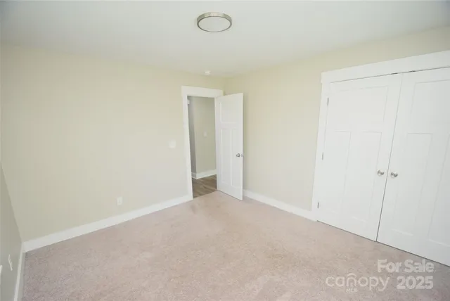 a bedroom with a bed and painting on the wall