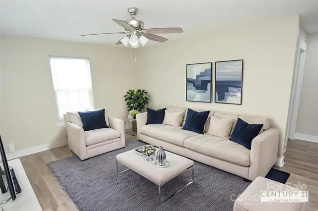 a living room with furniture and a large window
