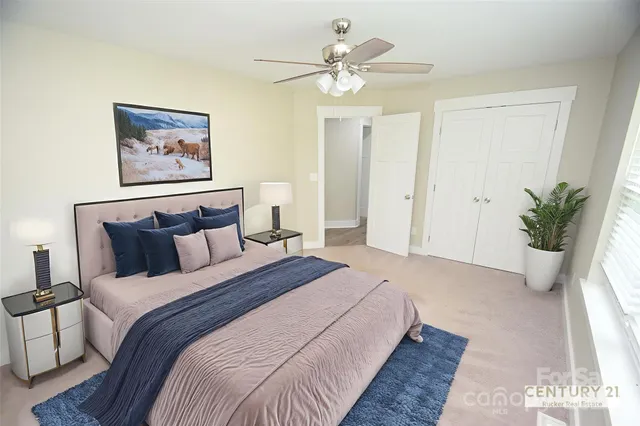 an empty room with a chandelier fan and windows