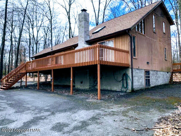 139 Dunchurch Drive Bushkill, PA 18324 - Photo 1 of 12 a view of a house with a yard and deck under a large tree