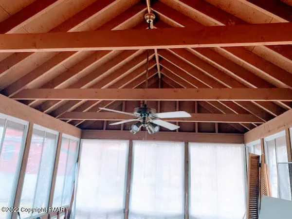 a view of a room with wooden ceiling