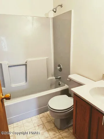 a white toilet sitting next to a bath tub