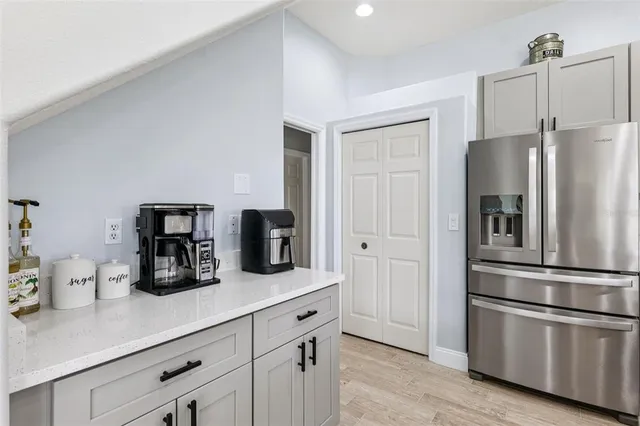 a kitchen with refrigerator and cabinets