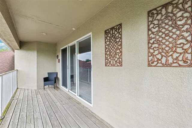 a view of a room with wooden floor and furniture