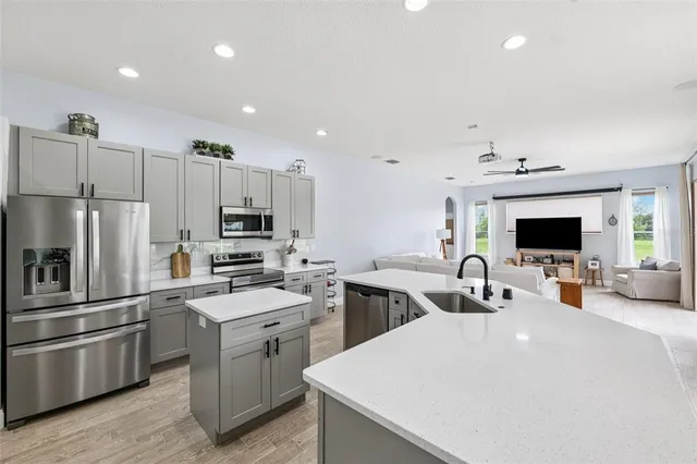 a kitchen with a sink stainless steel appliances and cabinets