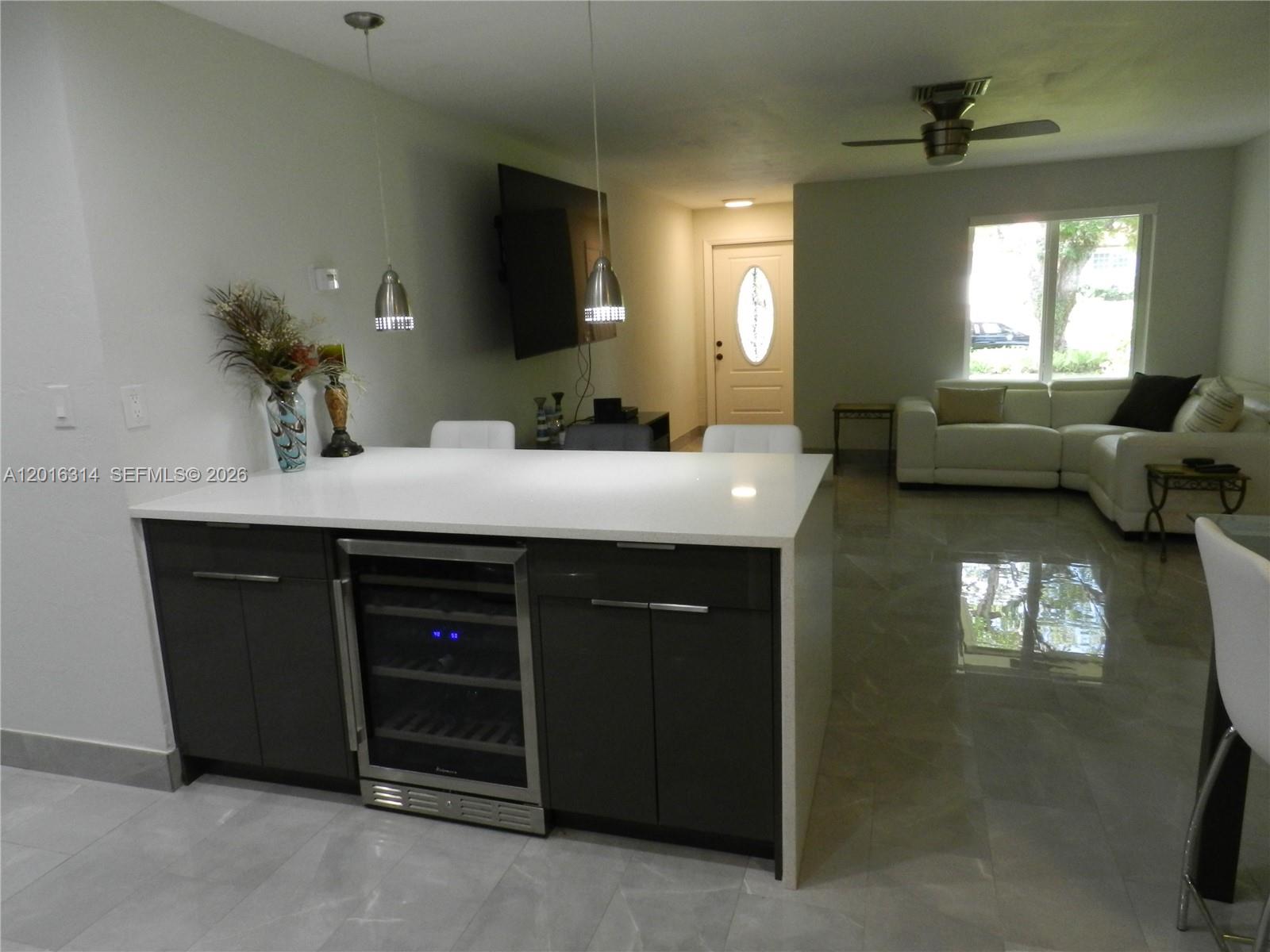 305 Northwest 42nd Street Boca Raton, FL 33431 - Photo 21 of 31 a living room with furniture and a flat screen tv