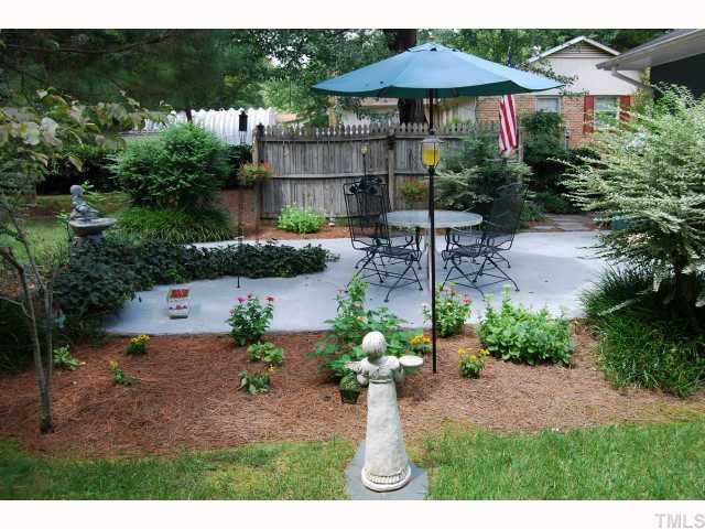613 Northclift Drive Raleigh, NC 27609 - Photo 10 of 12 Charming patio and water fountain will surround you in this backyard oasis.