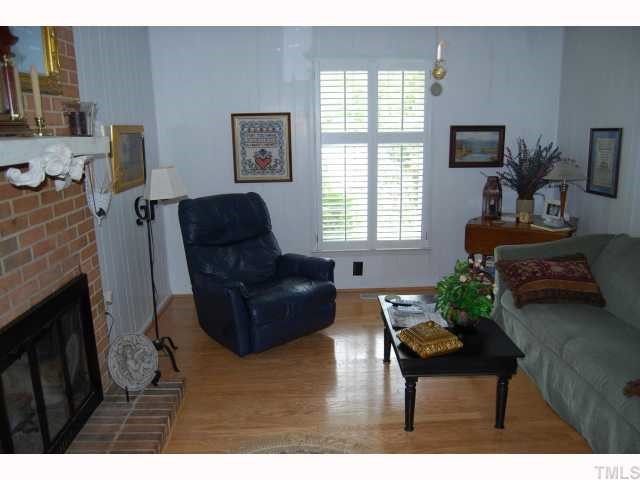 613 Northclift Drive Raleigh, NC 27609 - Photo 2 of 12 Plantation shutters, hardwood floors and a gas log fireplace are in the freshly painted family room.