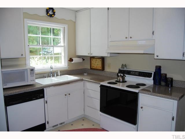 613 Northclift Drive Raleigh, NC 27609 - Photo 3 of 12 Brushed nickel hardware and granite-like counters in this renovated kitchen.