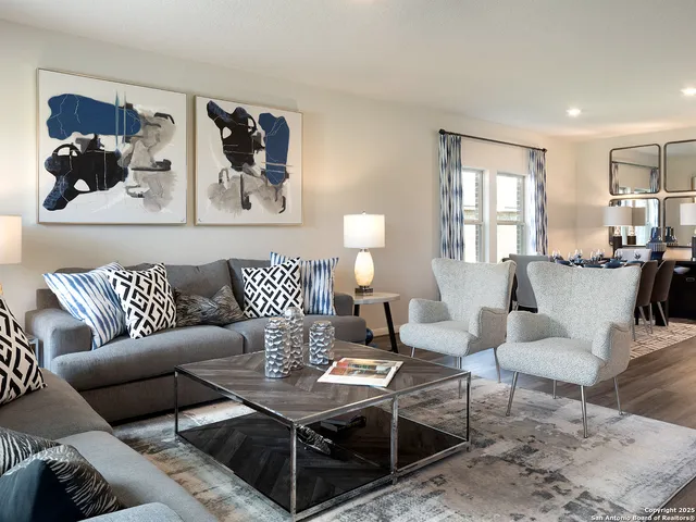 a living room with furniture lamp and window