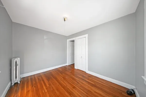 a view of room with wooden floor