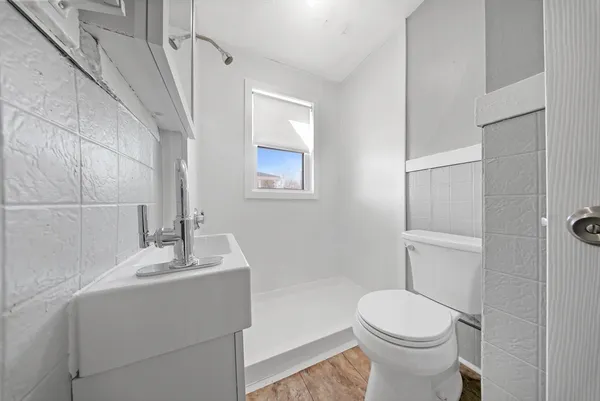 a bathroom with a sink toilet and shower