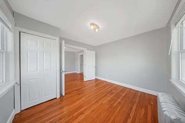 a view of room with window and wooden floor