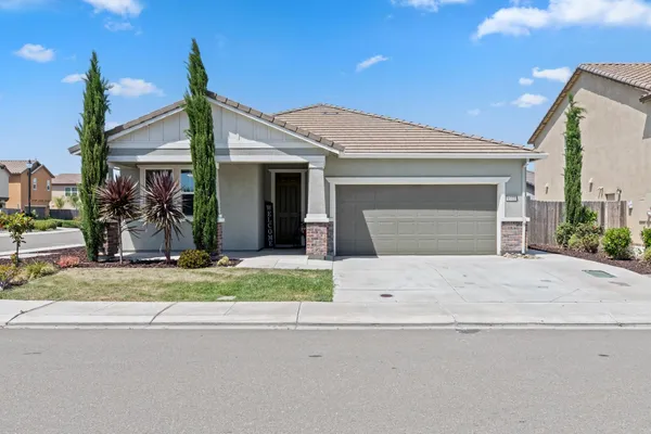a front view of a house with a yard and garage
