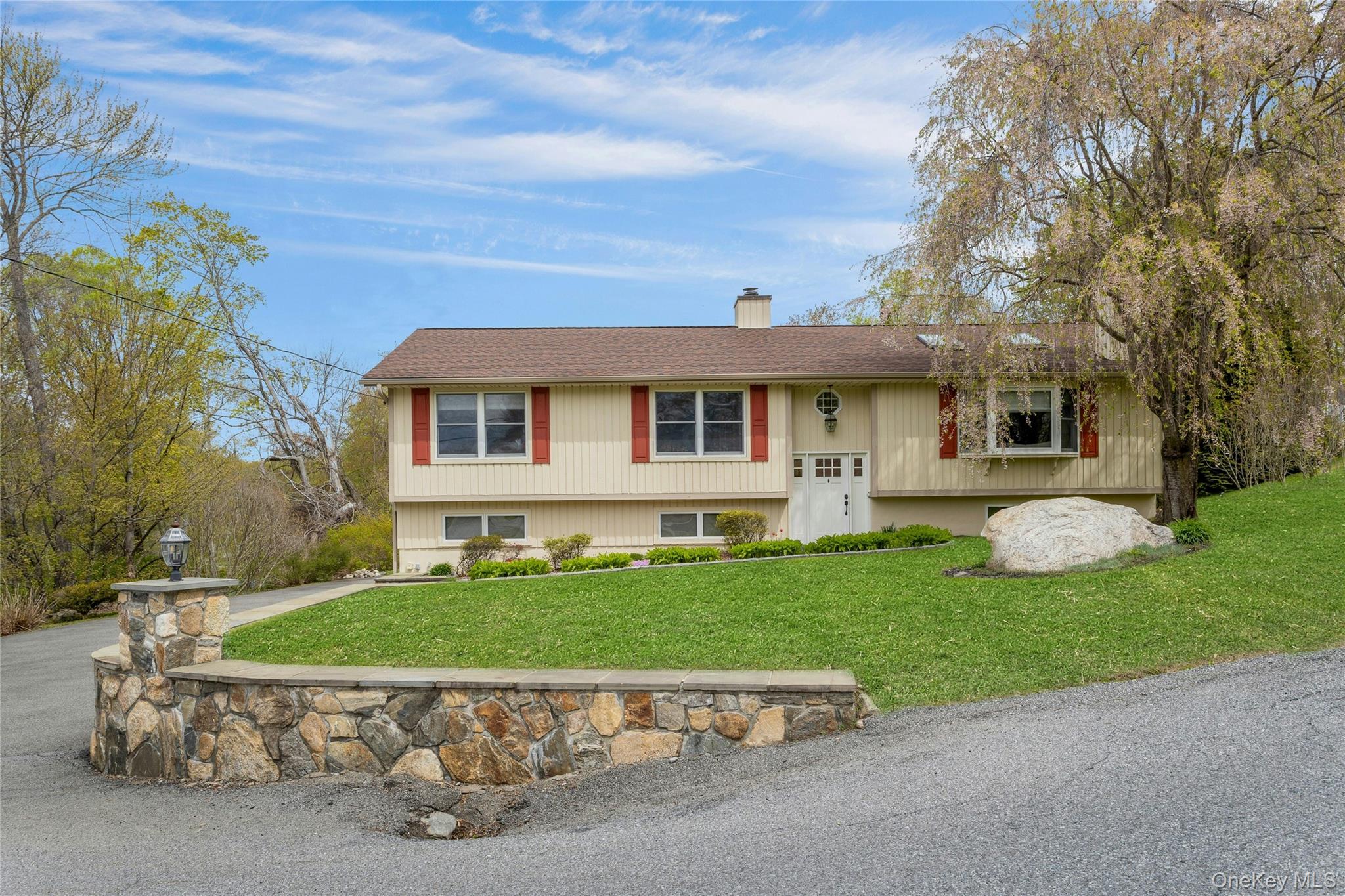 340 Osceola Road Jefferson Valley, NY 10535 - Photo 3 of 48 a front view of a house with a garden