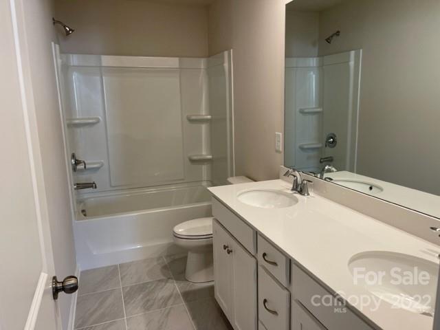 6525 Gopher Road, Unit 361 Lancaster, SC 29720 - Photo 10 of 26 a bathroom with a sink a toilet a mirror a bathtub and shower