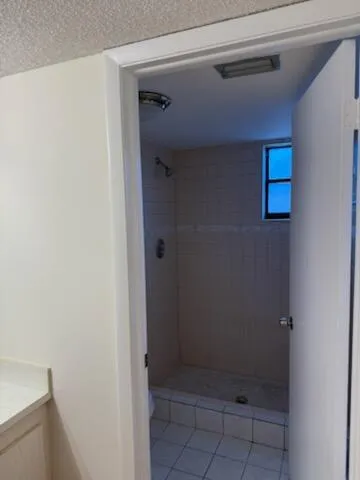 a bathroom with a glass door shower