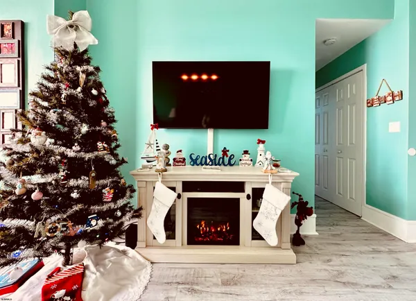 a living room with a fireplace wooden floor and a couch