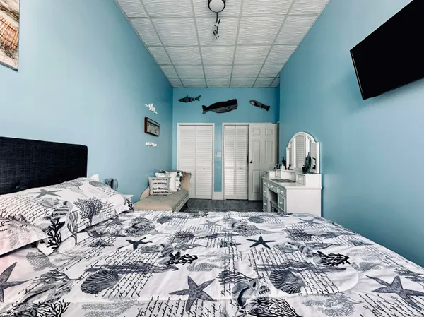 a bedroom with a bed and a television