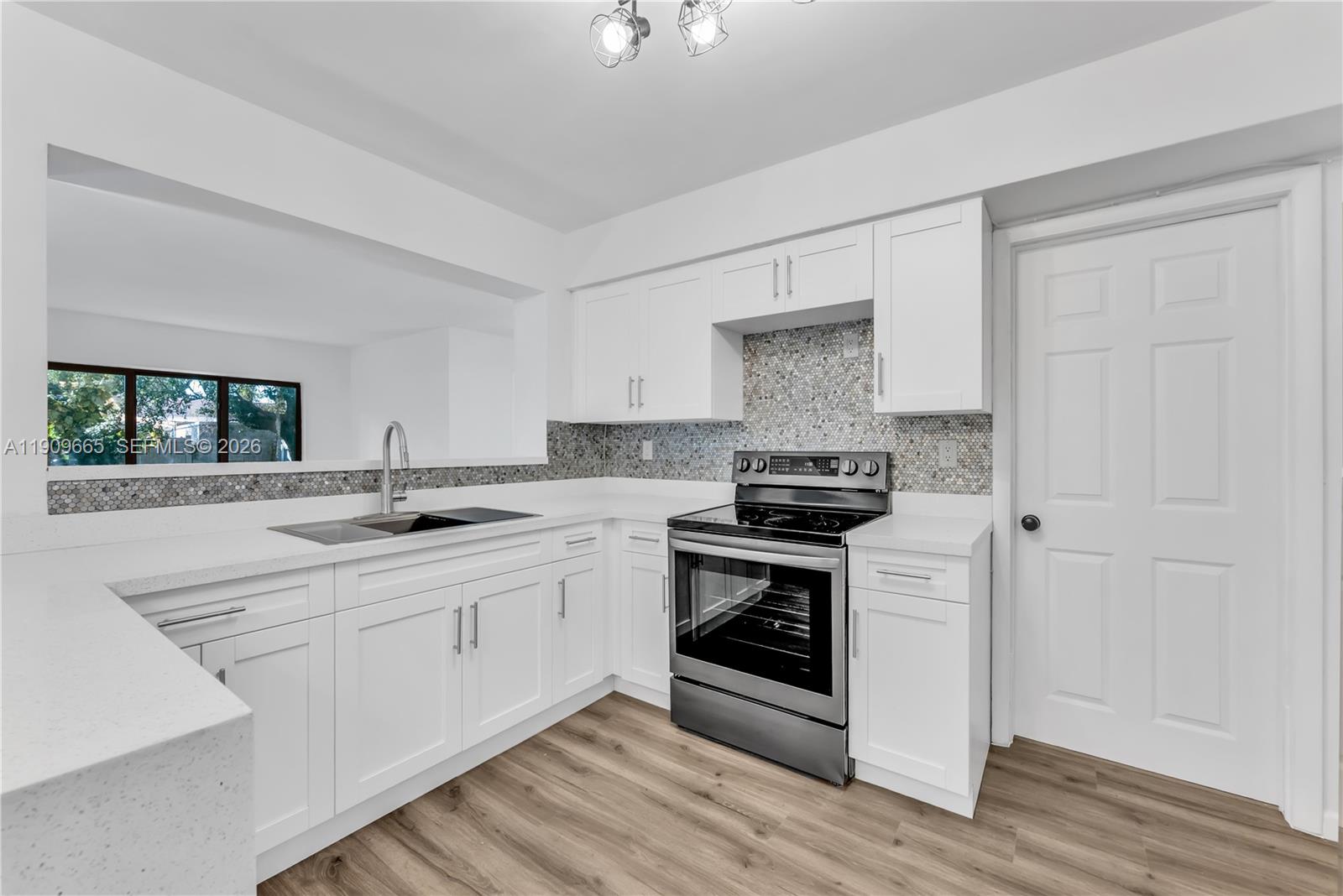 a kitchen with stainless steel appliances granite countertop a stove and a sink