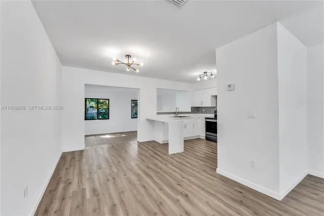 a view of kitchen view with wooden floor and a kitchen