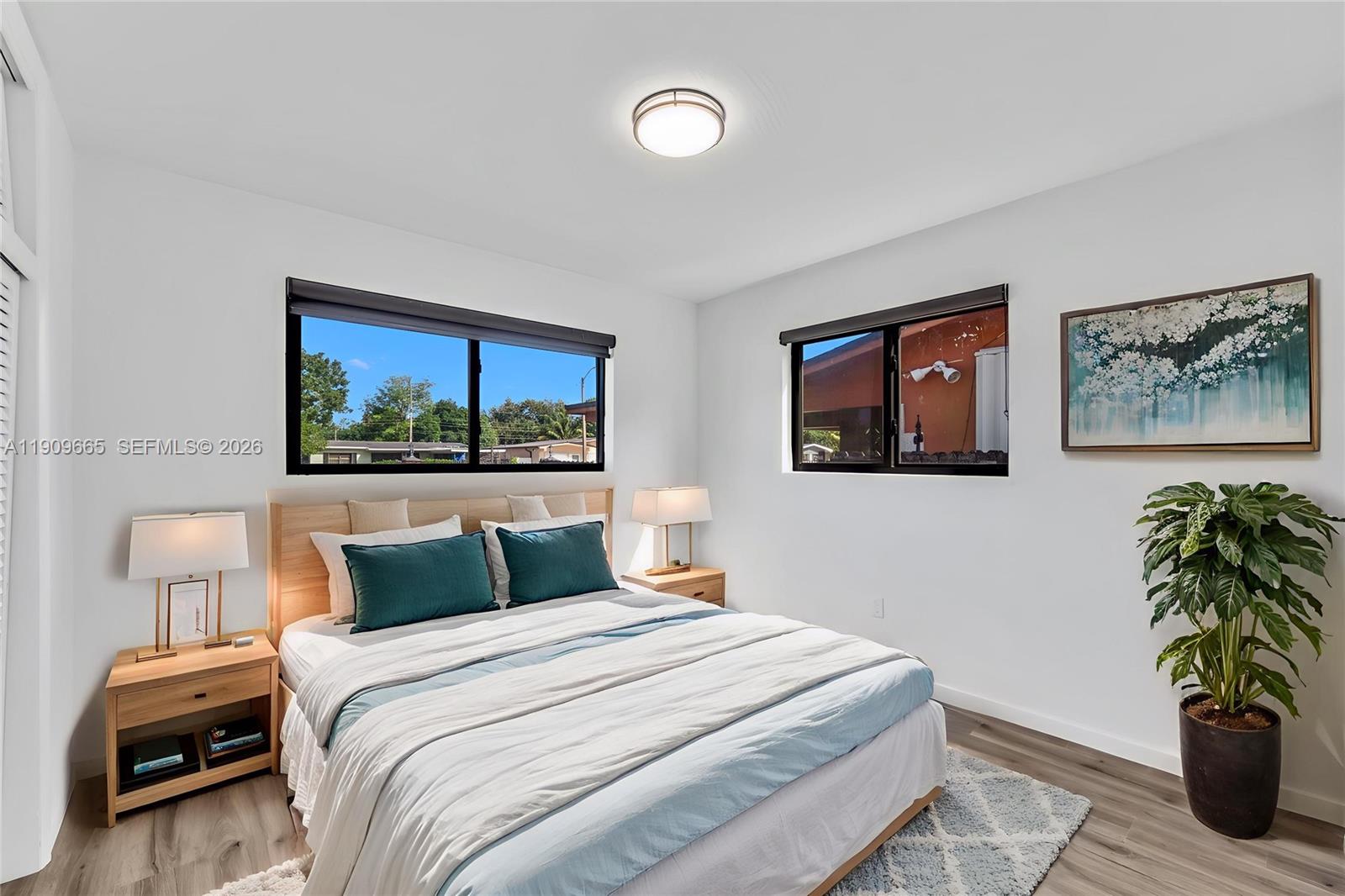 3040 Northwest 96th Street Miami, FL 33147 - Photo 21 of 26 a bedroom with a bed and a painting on the wall