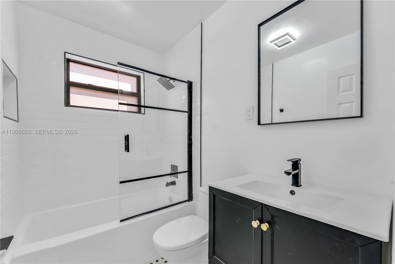3040 Northwest 96th Street Miami, FL 33147 - Photo 4 of 26 a bathroom with a sink a toilet and shower