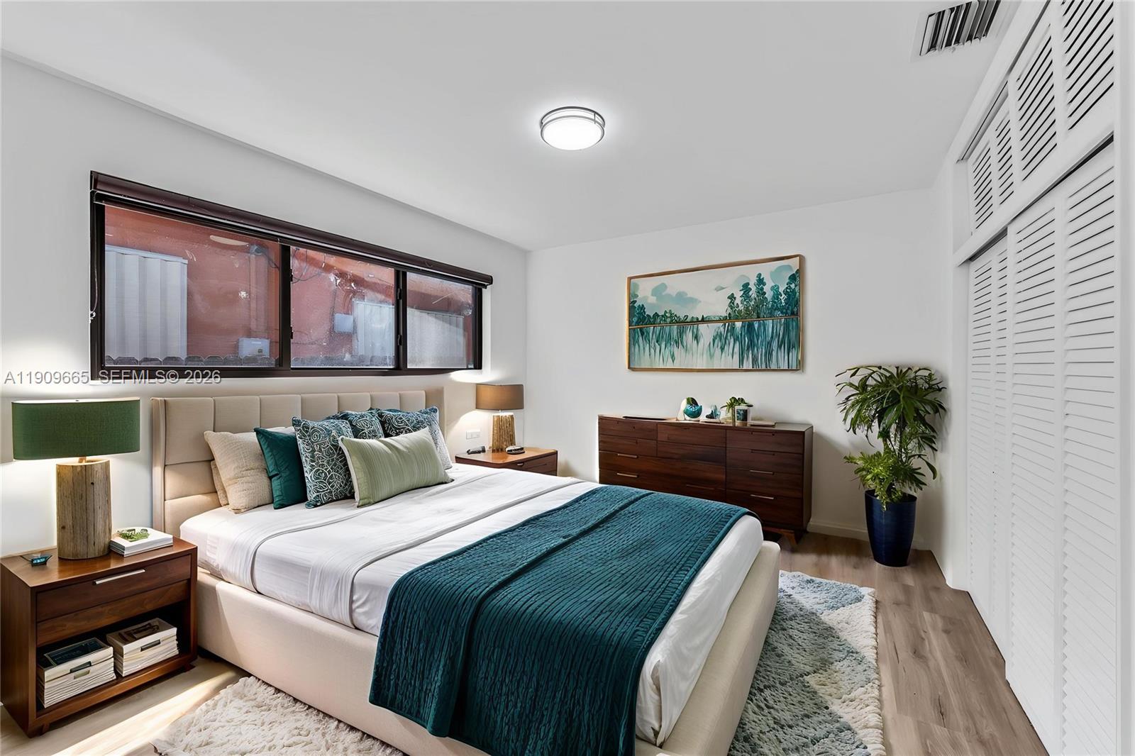 3040 Northwest 96th Street Miami, FL 33147 - Photo 4 of 26 a bedroom with a large bed and a potted plant