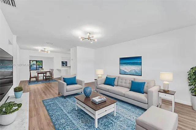 a living room with furniture a rug and a lamp