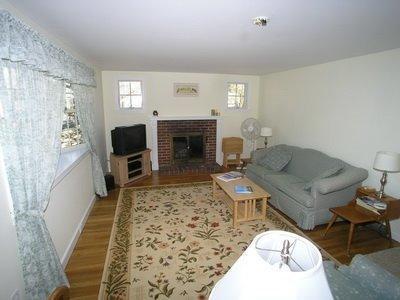 5 Wood Road Dennis Port, MA 02639 - Photo 2 of 7 a living room with furniture a fireplace and a flat screen tv