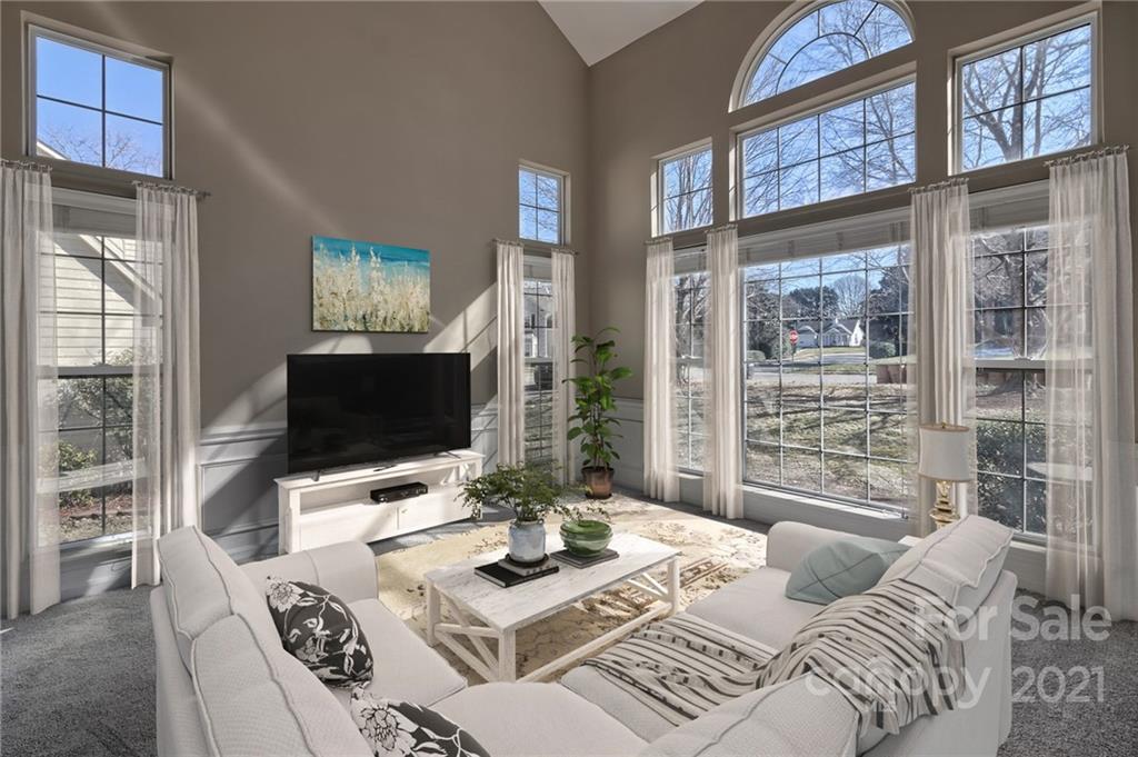 4821 Brownes Ferry Road Charlotte, NC 28269 - Photo 12 of 37 a living room with furniture a flat screen tv and a large window